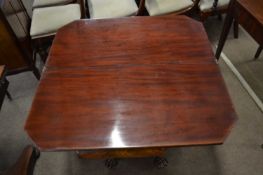 Mid 19th Century mahogany folding tea table raised on a tapering column with four carved paw feet,