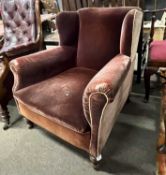 A late 19th Century wing back velour upholstered armchair