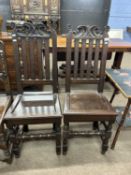 A pair of 18th Century hard seated hall chairs with carved pediments and turned front legs