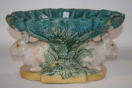 A 19th/20th Century Minton style Maiolica centre piece with a bowl supported by two rabbits, 30cm