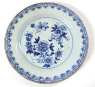 An 18th Century Chinese porcelain plate with a floral blue and white design (rim chip)
