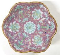 A Chinese porcelain bowl of petal shape, the pink ground decorated with flowers, 18cm diameter,