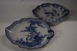 Two Japanese porcelain leaf shaped dishes decorated in blue and white with birds in branches,