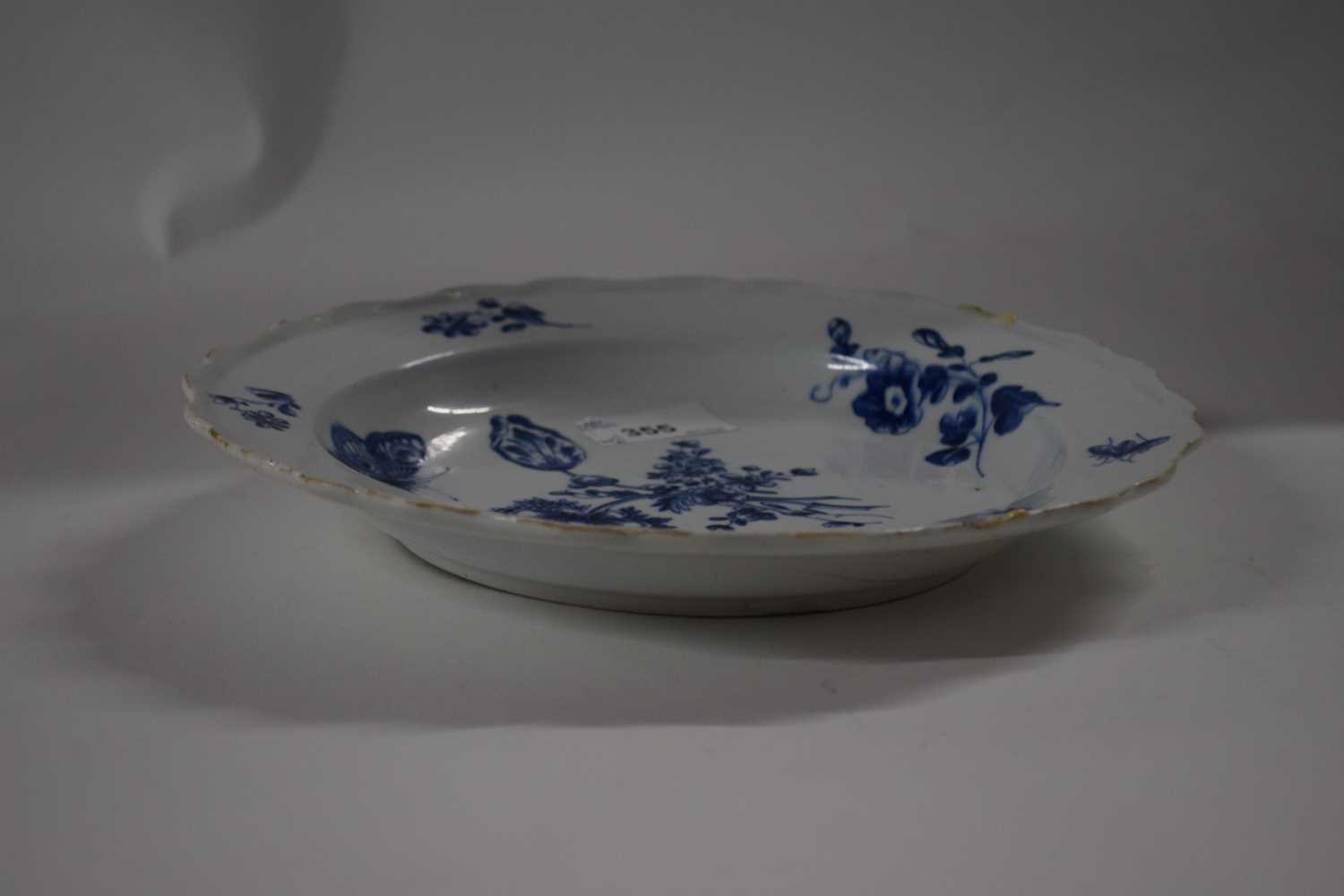 An 18th Century English porcelain plate painted with floral sprays and butterfliees in blue and - Image 2 of 2