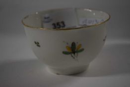 An 18th Century English porcelain tea bowl with famille vert decoration of flowers highlighted in
