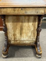 A Victorian walnut Davenport desk of typical form with wedge formed top over a base with four