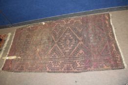 A Middle Eastern wool floor rug decorated with geometric design, 185 x 97cm