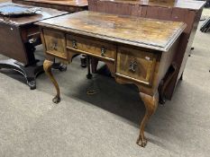 Early 20th Century walnut veneered three drawer low boy raised on cabriole legs with ball and claw