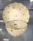 A Lowestoft porcelain tea bowl and saucer of fluted shape with gilt chevron design, circa 1790,