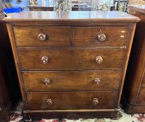 A Victorian mahogany chest of two short over three long drawers fitted with turned knob handles,