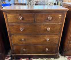 A Victorian mahogany chest of two short over three long drawers fitted with turned knob handles,