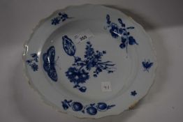 An 18th Century English porcelain plate painted with floral sprays and butterfliees in blue and