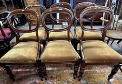 A set of six Victorian mahogany balloon back dining chairs with drop in seats and turned front