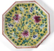 A small Chinese porcelain octagonal plate or stand, the yellow ground with famille rose floral