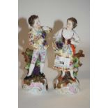 A pair of late 19th Century continental porcelain figures of flower sellers, 17cm high