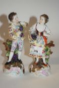 A pair of late 19th Century continental porcelain figures of flower sellers, 17cm high