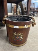 A hardwood and brass bound coal bucket with metal liner, the front of the bucket decorated with a
