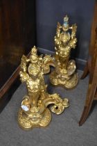 A pair of unusual classical formed gilt painted fireside metal ornaments or fire dogs formed as