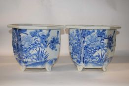 A pair of Japanese porcelain octagonal shape jardinieres decorated in blue and white with flowers