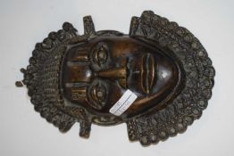 A bronze mask possibly of African origin