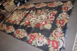 A large floral needlework shallow pile rug decorated with various flowers and signed Sofia Nistob,