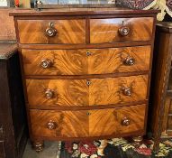A Victorian mahogany bow front chest with two short over three long drawers raised on turned feet,