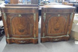 A pair of unusual continental serpentine front and barrel back corner cabinets the single doors