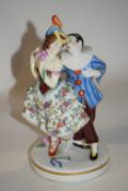 A continental porcelain model of a Harlequin and Columbine on circular base, 19cm high