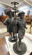 A pair of late 19th or early 20th Century Spelter lamp bases formed as medieval figures raise on