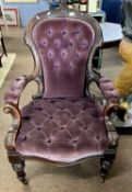 A late Victorian hardwood framed armchair with purple draylon covering, raised on turned front