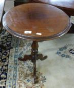 A Victorian mahogany wine table with circular top over a turned column and tripod base, 72cm high