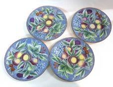 An unusual group of four pearl ware plates, the blue ground with a design of fruit, early 19th