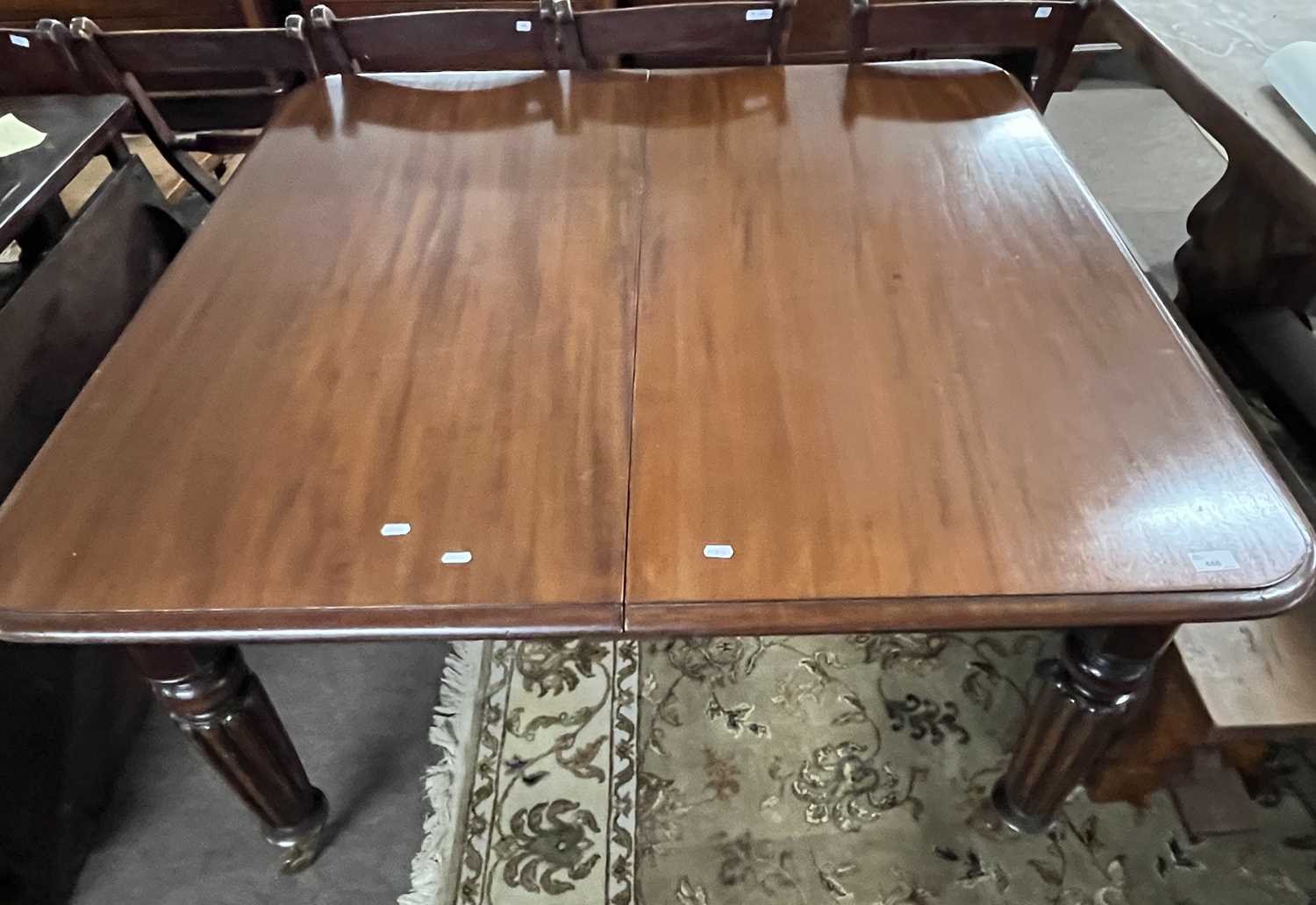 A large Victorian mahogany extending dining table on turned fluted legs with pull out action and two - Image 4 of 4