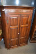 A large Georgian mahogany corner cabinet with two panelled doors and inlaid decoration, 128cm high
