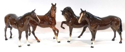 A group of four Beswick horses (one with leg a/f)