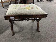 A Victorian rosewood footstool with rectangular top with tapestry covering and an "X" formed