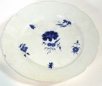 A porcelain plate, probably 18th Century with painted blue flowers within a basket weave border,