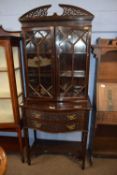 Edwardian mahogany display cabinet with pierced arch pediment, two glazed doors and serpentine