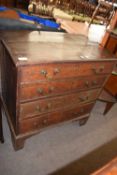 A George III oak chest of drawers of small proportions with four graduated drawers with brass swan