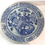 A large Oriental charger, probably 19th Century with blue and white design of birds in branches, the