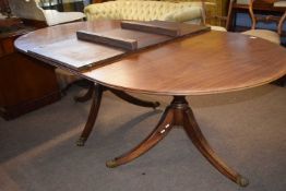 A Georgian style mahogany twin pedestal dining table with extra extension leaf, 194cm long, the