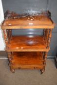 A Victorian three tier rosewood what not with turned sides supports and fretwork detail on short