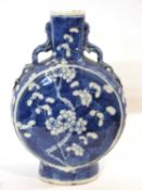 A Chinese porcelain moon flask, the blue ground with prunus decoration, 19th Century, four character
