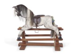 Horseplay, Devon a contemporary dappled grey rocking horse set on a wooden base with turned