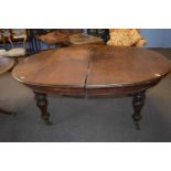 Large 19th Century mahogany extending dining table of oval form, set on turned legs, lacking its