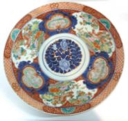 A large Japanese porcelain charger Meiji period decorated in Imari style with panels of birds,