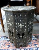 A Middle Eastern mother of pearl and bone inlaid octagonal occasional table, 50cm high, some