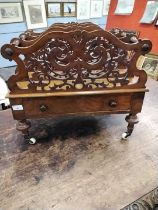 A Victorian walnut Canterbury magazine rack with three section top with pierced dividers over a