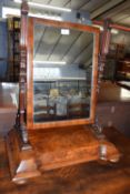 A Victorian mahogany framed swing dressing table mirror with scrolled side supports and plinth base,