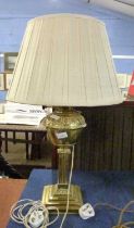 A brass oil lamp with shade